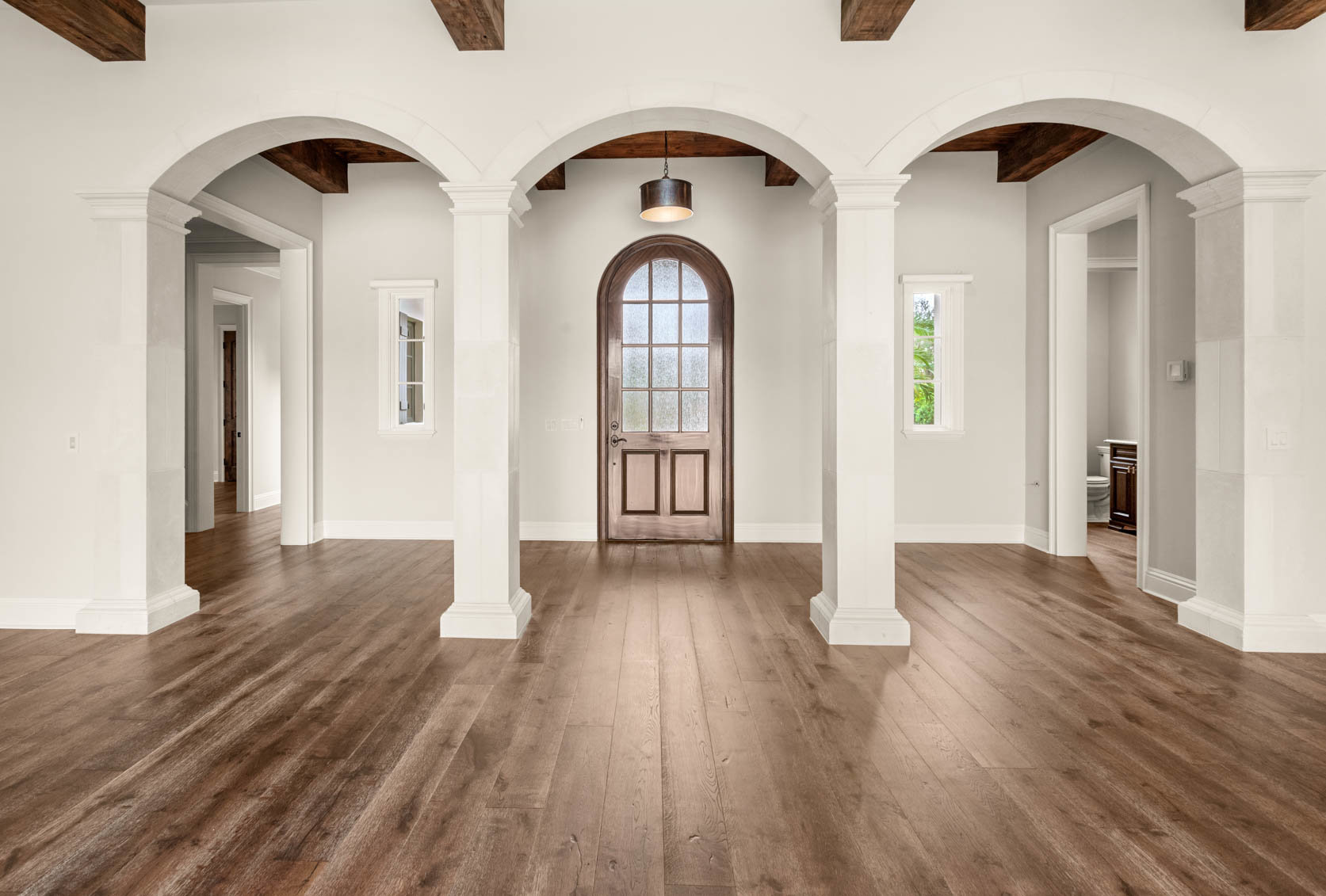 inside wooden front door with white pillars